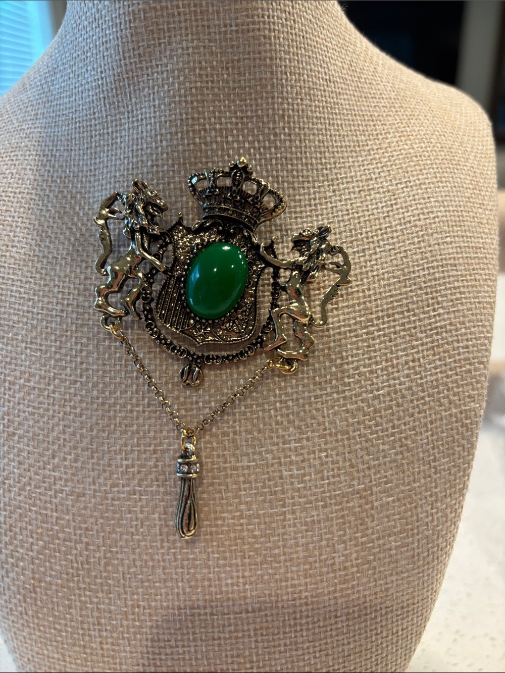 Vintage-Inspired Gold Crest Brooch with Green Stone